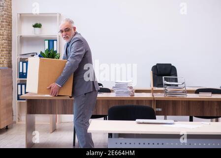 Old employee being fired from his work Stock Photo