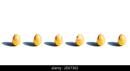 Some gold eggs stay in row on white background, isolated on white with shadow Stock Photo