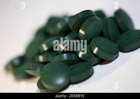 Green pills macro background spirulina platensis super food modern high quality print Stock Photo