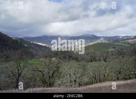 Dusting of snow covers hills after a cold winter storm in January 2021 in Sonoma County, California. Stock Photo