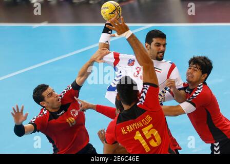Sahbi Aziza C Of Qatar S Al Rayyan Tries To Score Next To Abbas Alsaffar And Milos Maksimovic R Of Saudi Arabi S Mudhar During The Asian Handball Club Championship In Doha November 10 2012