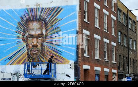 Street artist James Cochran, also known as Jimmy C, works on his spray painted picture of Jamaican sprinter Usain Bolt in Sclater street car park in east London July 19, 2012. Cochran said this was done as an homage to the London 2012 Olympic Games, which begin July 27. REUTERS/Paul Hackett  (BRITAIN - Tags: SPORT OLYMPICS ATHLETICS ENTERTAINMENT)
