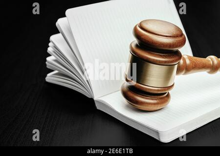 Brown wooden judge mallet on the background of open book Stock Photo