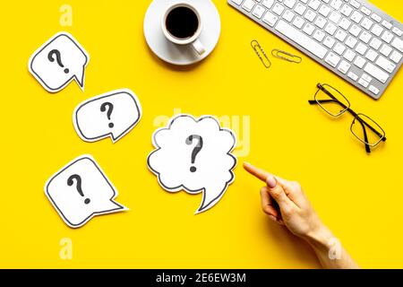 Question mark on speech bubbles with hand, top view. Solution concept Stock Photo