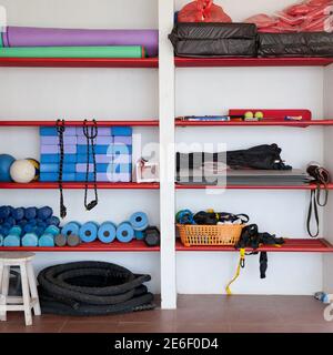 shelves with sports equipment in the gym. Different tools for fitness Stock Photo