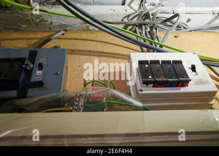 Electrician refitting and testing a new fuse board and safety checking wiring Stock Photo