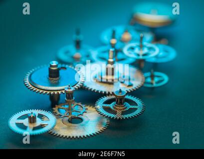 Close up of Steampunk Clock Cogs on blue background Stock Photo