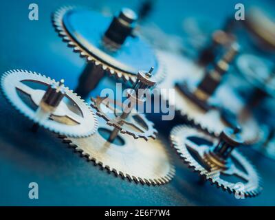 Clockwork vintage parts and steampunk cogs gears background. Aged mechanical clock wheels close-up. Shallow depth of field Stock Photo