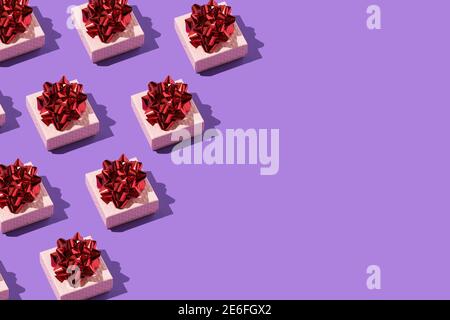 Gift with a red bow pattern on the purple background with text place banner for holidays Stock Photo