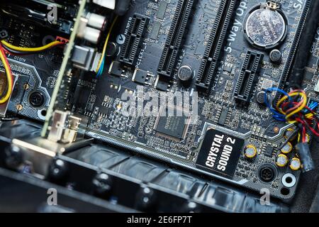 Gifhorn, Germany, Januara 16., 2021: Partial view of the motherboard of a computer with the sound chip and the battery for the internal clock of the m Stock Photo