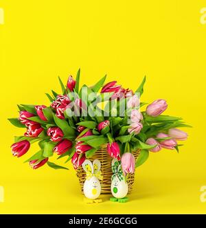 Easter greeting card with eggs bunny and tulips flowers on yellow  Stock Photo