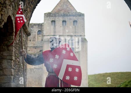 Medieval English knight stands at castle entrance Stock Photo