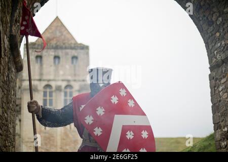 Medieval English knight stands at castle entrance Stock Photo