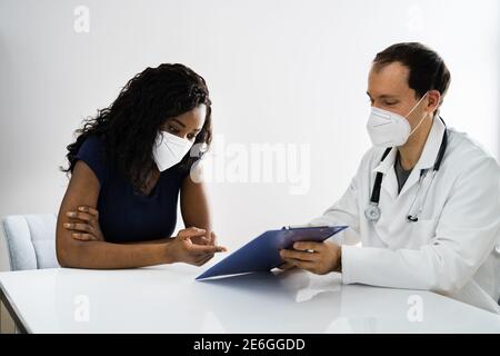 African American Patient At Hospital Meeting Doctor In Face Mask Stock Photo