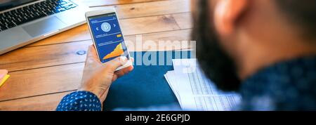 Businessman looking mobile with bitcoins information Stock Photo