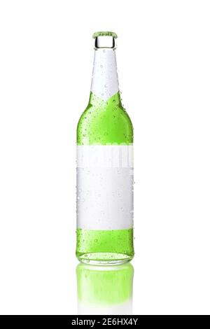 Single transparent glass bottle with blank white label. Bottle with green drink covered with water drops and isolated on white. Alcoholic drinks and r Stock Photo