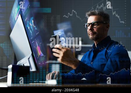Financial Data Analyst Using Mobile Analytics On Smartphone Stock Photo