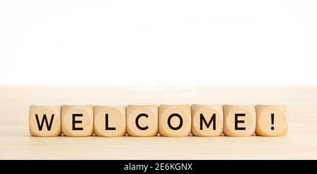 WELCOME word on wooden blocks on wood table. Copy space. White background Stock Photo