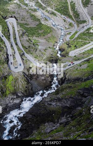 Close up of the hairpin bends of Trollstigen mountain pass with Stigfossen waterfall in Norway