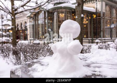 Snowman, snow woman molded from snow. Snowy winter concept. High quality photo Stock Photo