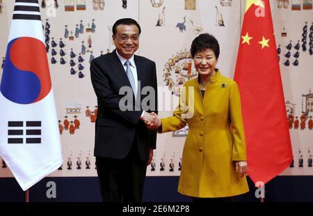 South Korean President Park Geun-hye (R) shakes hands with Chinese Premier Li Keqiang before their meeting at the presidential Blue House in Seoul, South Korea, October 31, 2015. REUTERS/Lee Jin-man/Pool