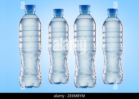 Set of plastic water bottles on a blue background Stock Photo