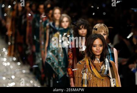 Models present creations from the Burberry Prorsum Autumn/Winter 2015 collection during London Fashion Week in this February 23, 2015 file photo. British luxury fashion brand Burberry said on February 5, 2016 it would merge its four annual catwalk shows into two and make its runway collections available to shoppers immediately. REUTERS/Suzanne Plunkett/Files
