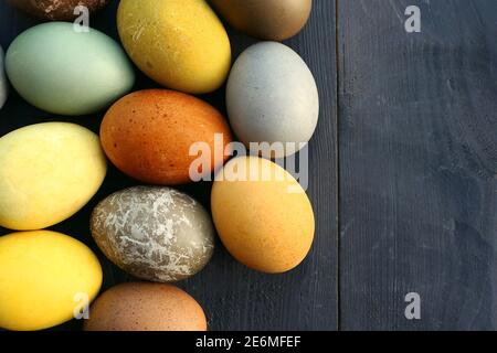 Naturally dyed Easter eggs on wooden black background. Stock Photo