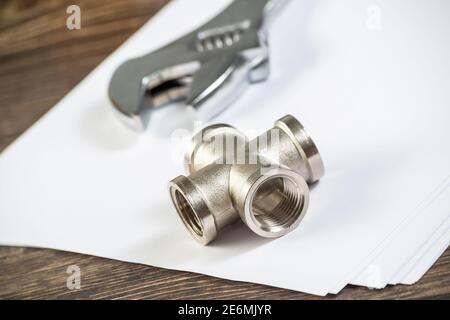 Plumbing pipeline element and adjustable wrench Stock Photo