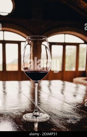 A glass of red wine on rustic wooden table Stock Photo