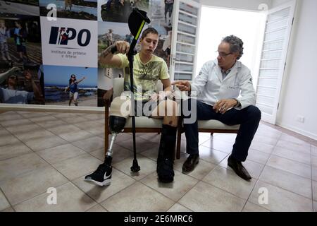 Goalkeeper Jackson Follmann, who survived when the plane carrying Brazilian soccer team Chapecoense crashed, talks with Dr. Jose Carvalho as they try on a prosthetic leg in Sao Paulo, Brazil, February 21, 2017. REUTERS/Paulo Whitaker