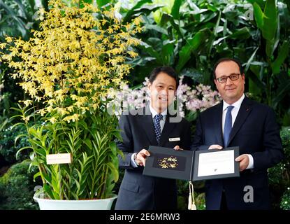 French President Francois Hollande poses with the Dendrobium Francois Hollande during an orchid-naming ceremony at the Singapore Botanic Gardens March 27, 2017. REUTERS/Edgar Su