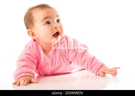 6 month old baby girl crawling on white background. Stock Photo