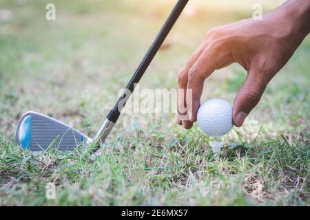 The golf player putting golf ball on tee against with a golf club Stock Photo