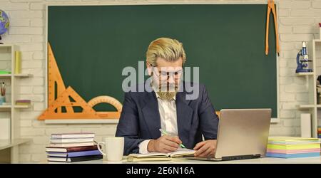 Teacher teaching programming language. Teacher at classroom. Watch ...