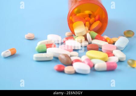 Close up of many colorful pills and capsules on blue background  Stock Photo