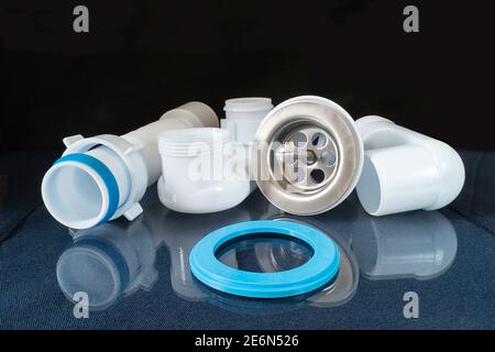 The Plastic siphon for sink on black background.Spare details for repair of the sink Stock Photo