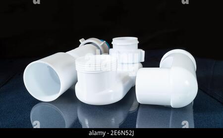 The Plastic siphon for sink on black background.Spare details for repair of the sink Stock Photo