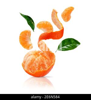 Peeled clementine, sliced mandarine with green leaves flying isolated on white background with clipping path. Stock Photo