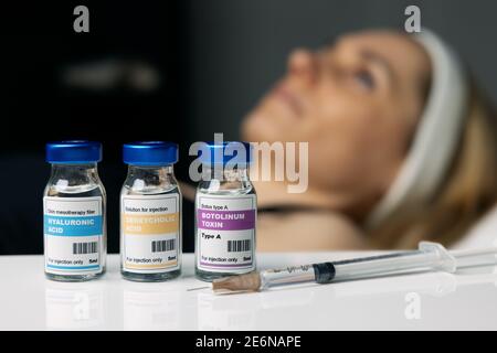 woman receiving cosmetic anti aging procedures at beauty salon. aesthetic treatment. injection vials Stock Photo