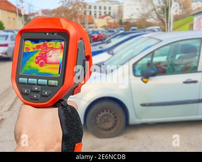 Recording with thermal camera showing parked cars at town parking a lot of Stock Photo