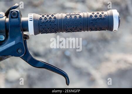 Part of a bicycle handlebar with a brake handle. Close-up Stock Photo