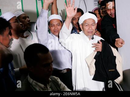 Supporters of Parti Islam SeMalaysia (PAS) celebrate in front of 