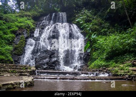 Watu Lumpang waterfall is a tourist destination in East Java. low and wide waterfall between cliffs and wilderness. tropical forest tourism in the hig Stock Photo