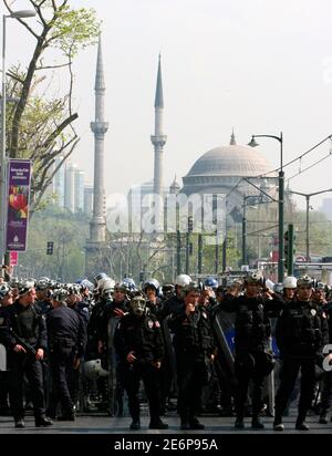 Riot police officers wearing gas masks block a street near the Dolmabahce Mosque to stop May Day protesters from forcing their way into Taksim Square in Istanbul May 1, 2007. Turkish police detained 580 people in Istanbul on Tuesday in street battles with leftist demonstrators protesting on the May Day anniversary of a mass shooting 30 years ago. Police charged at hundreds of protesters, many from leftist organisations, kicking and clubbing them in the city's main Taksim Square and neighbouring streets. REUTERS/Fatih Saribas (TURKEY)