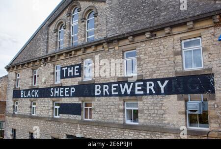 Large painted Black Sheep Brewery sign on the wall of the brewery building in Masham, North Yorkshire Stock Photo