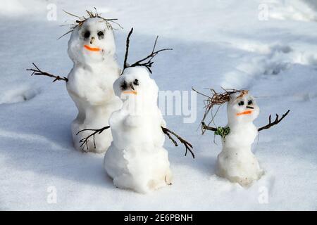 Winter-Spring story of the snowman family snowman-dad, snowman-mom, snowman-child in the snow Stock Photo