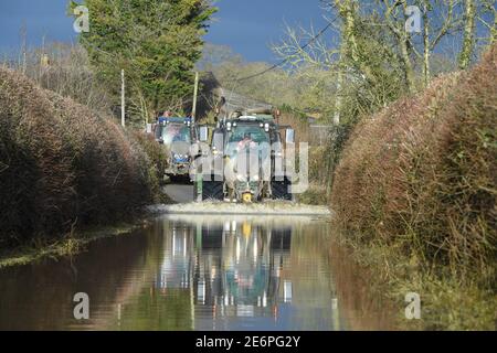 Caundle Marsh, near Sherborne, Dorset. 29th Jan, 2021. Tractors going through the flood waters near the village of Caundle Marsh. Credit:Peter Nixon/Alamy Live News Stock Photo