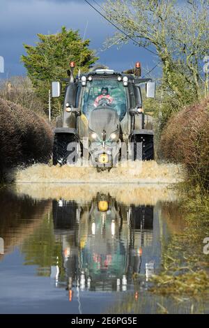 Caundle Marsh, near Sherborne, Dorset. 29th Jan, 2021. Tractors going through the flood waters near the village of Caundle Marsh. Credit:Peter Nixon/Alamy Live News Stock Photo