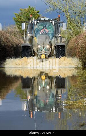 Caundle Marsh, near Sherborne, Dorset. 29th Jan, 2021. Tractors going through the flood waters near the village of Caundle Marsh. Credit:Peter Nixon/Alamy Live News Stock Photo